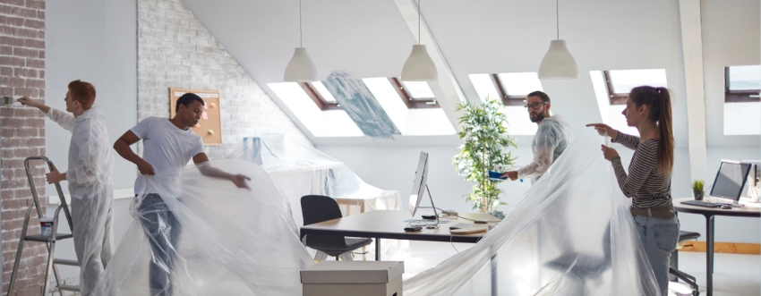 Handyman repairing drywall in a commercial space