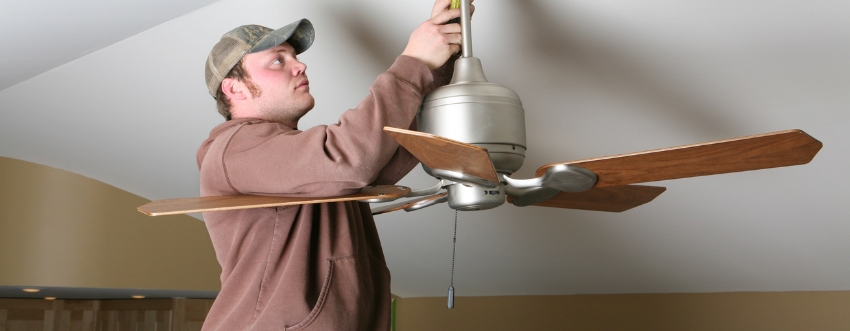 Handyman installing ceiling fan in Austin home