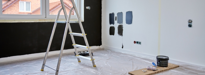 Handyman painting an exterior door